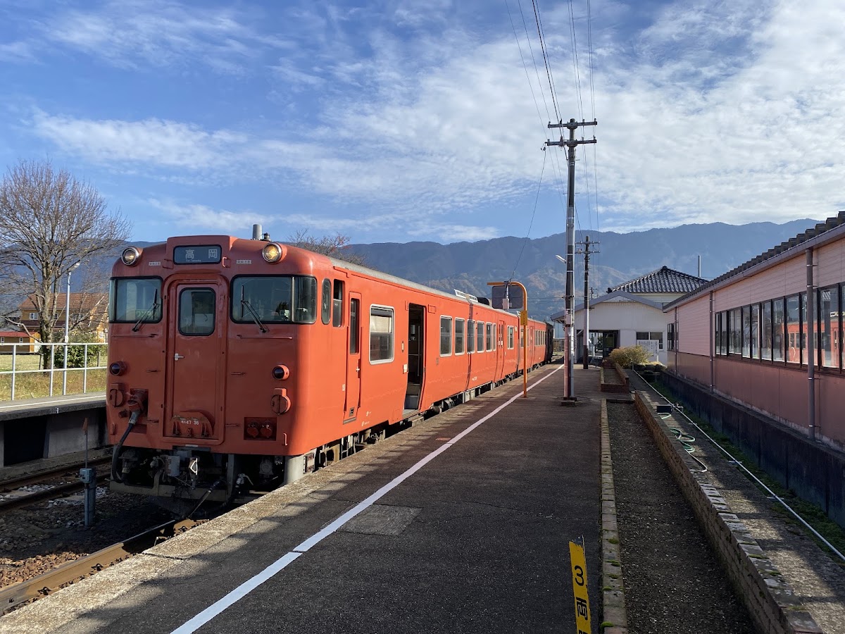月台停靠的紅色列車與山景