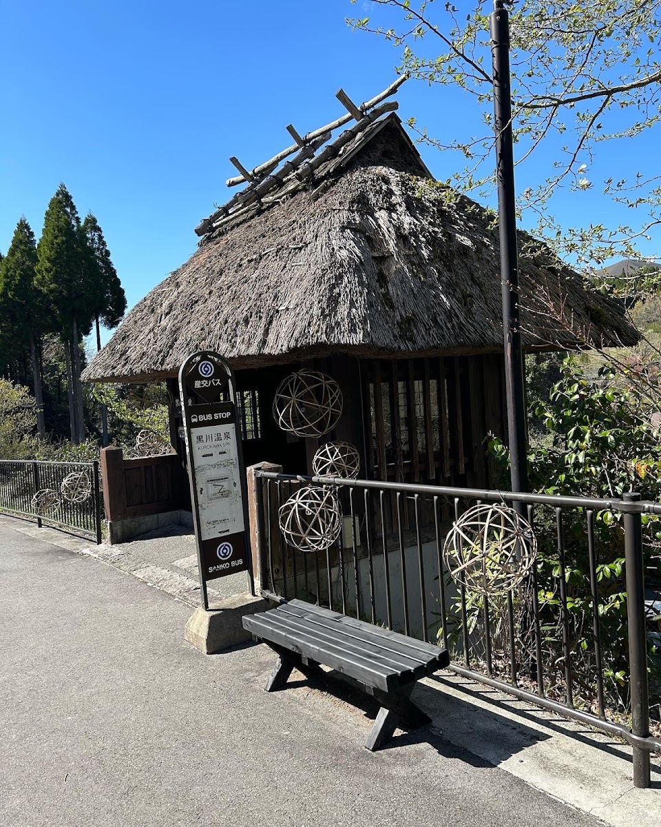 黑川溫泉公車站牌與草葺屋頂建築